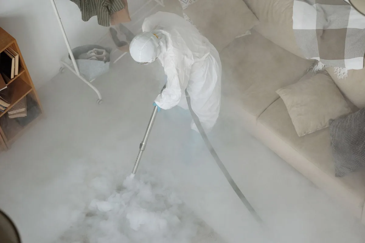 Biohazard cleanup technician in protective equipment, De Soto, IA